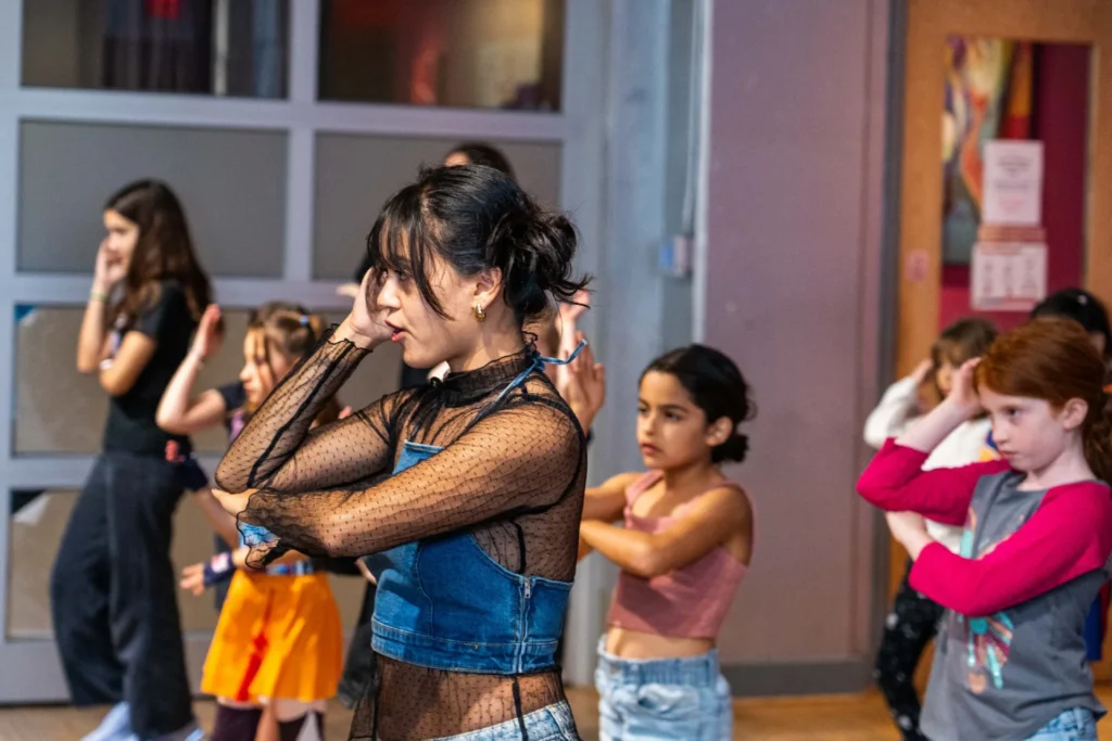Instructor teaching choreography to a group of kids