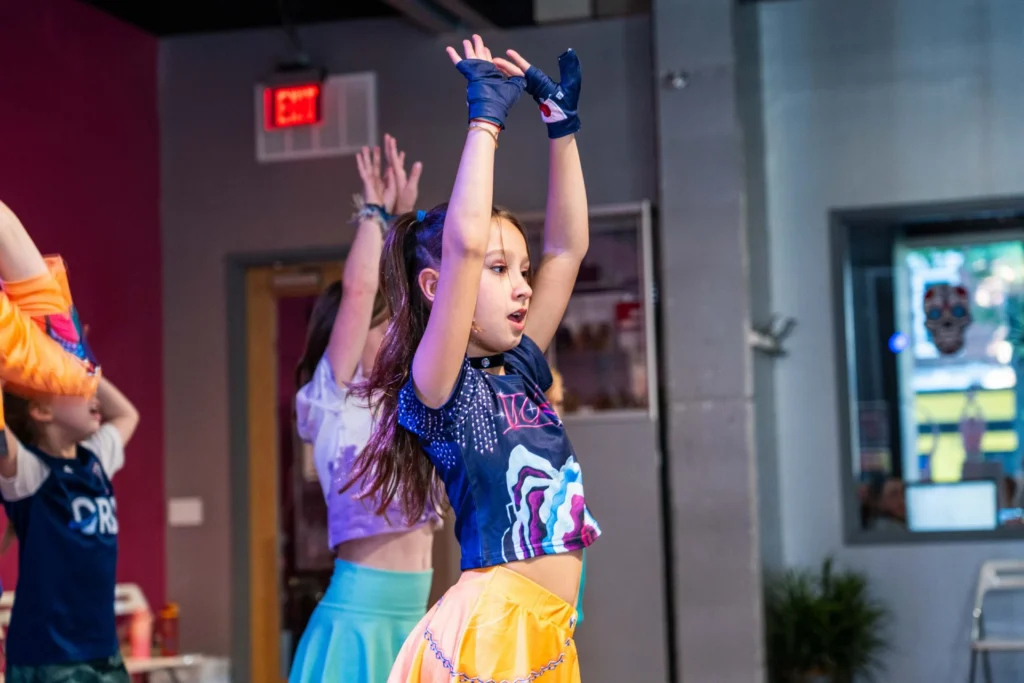 Young dancer performing a sharp K-pop arm sequence