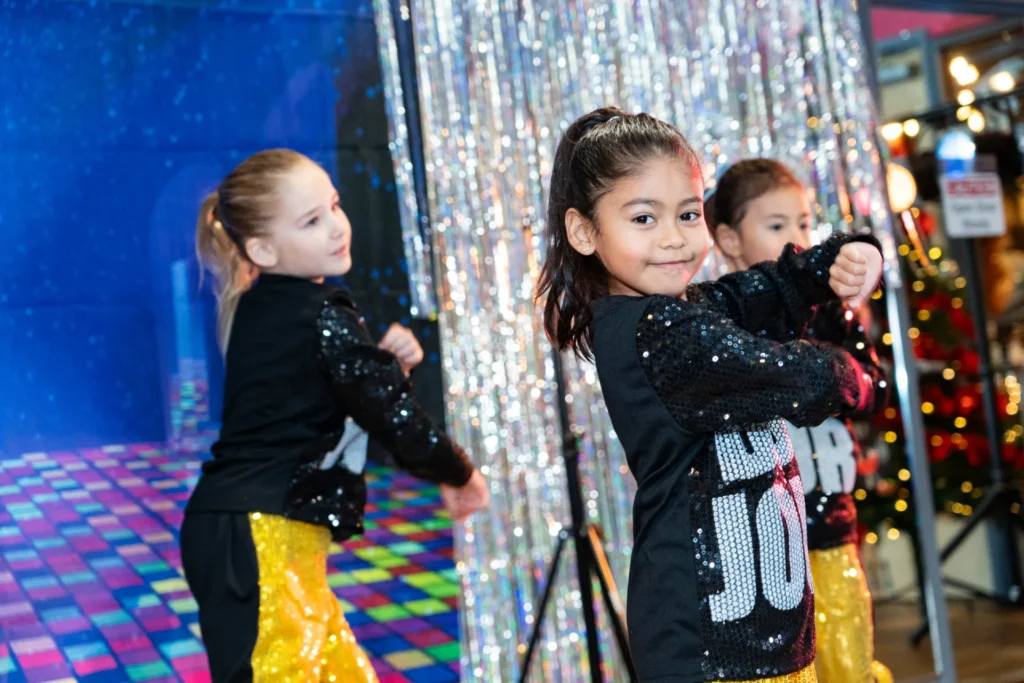 Young dancers performing in sequin costumes
