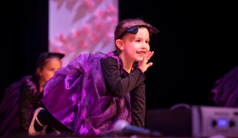 Young dancer performing expressively on stage