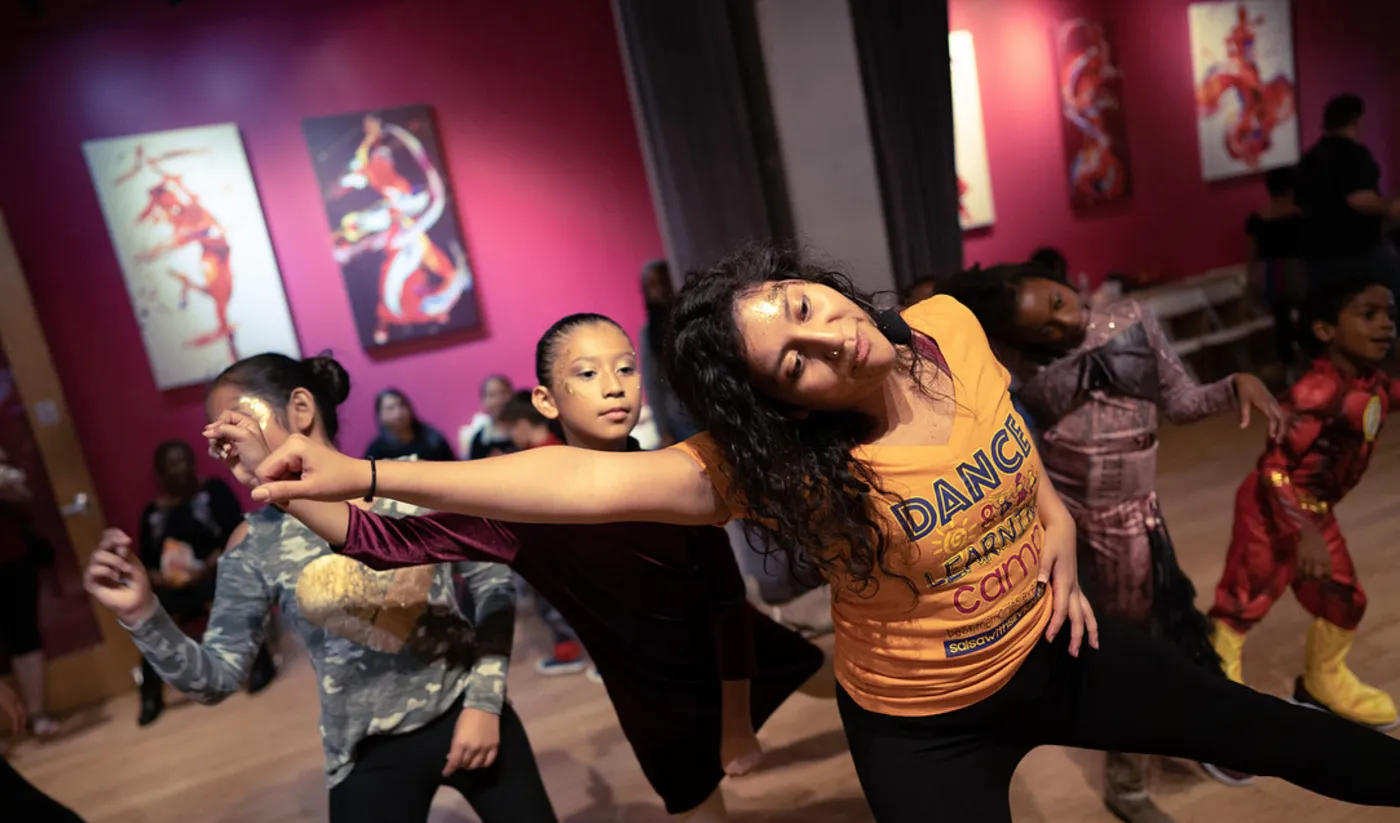 Dance teacher leading kids in costume through a Halloween dance routine in Washington DC