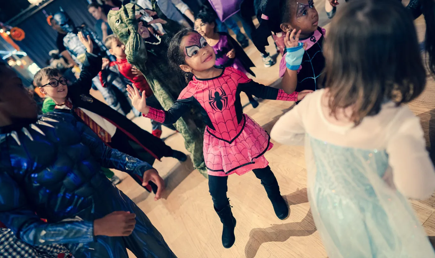 Kids dancing in superhero and princess costumes at a Halloween dance party in DC